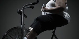 Overweight woman on exercise bike